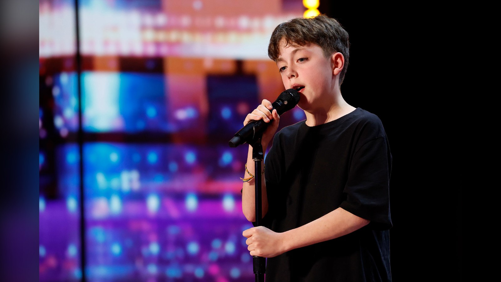 Alfie Andrew singing on stage