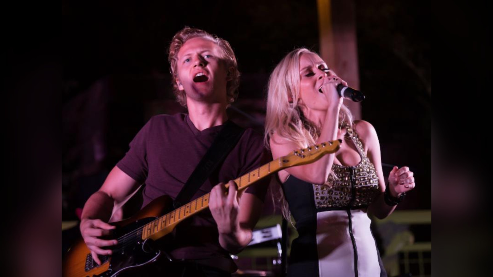 Makenna and Brock singing live together with a guitar