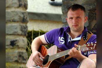 Robbie Kennedy with his acoustic guitar