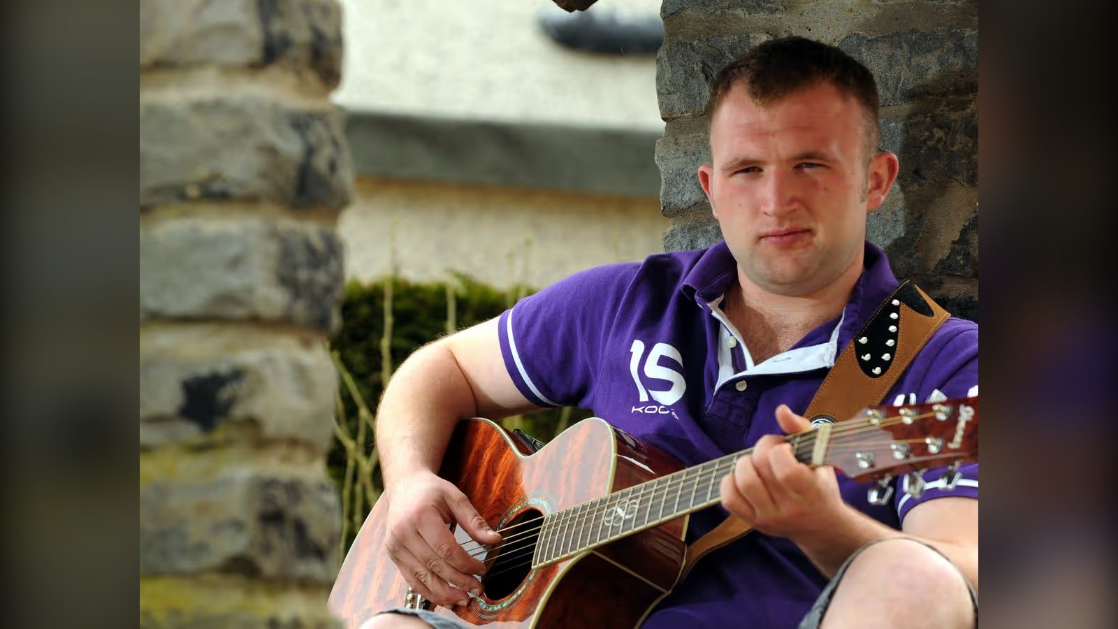 Robbie Kennedy with his acoustic guitar